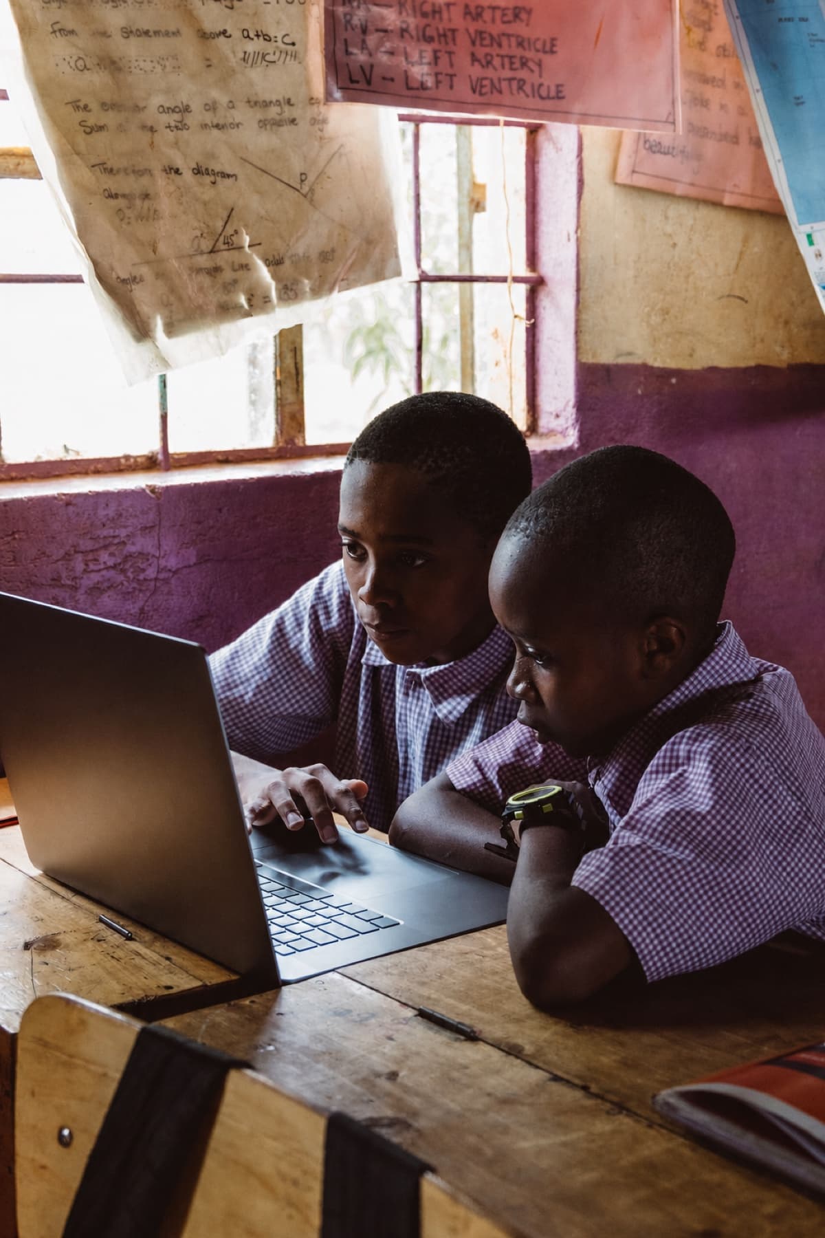 Students learning together with a laptop in class