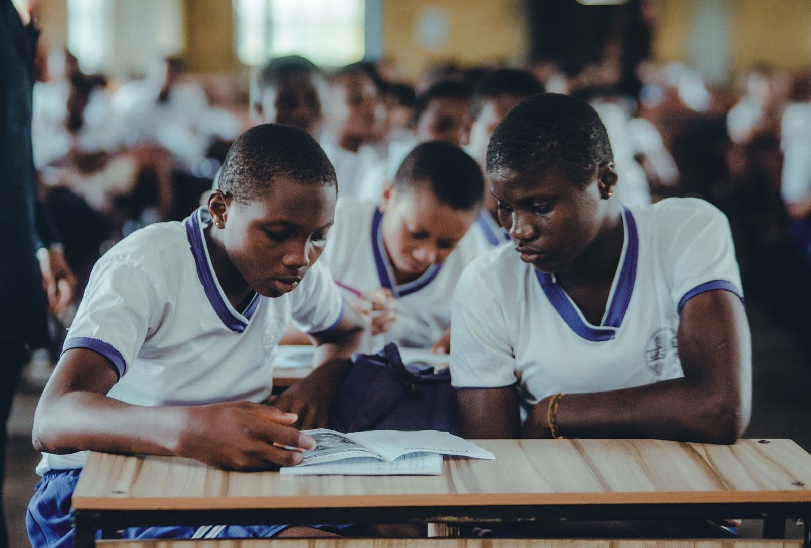 Secondary school students studying together in uniform